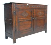 An early 20th Century Jacobean revival Ipswitch sideboard cupboard having twin doors with carved