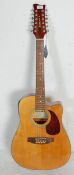 A 20th Century Legacy twelve string acoustic guitar having a cut away body with a tortoise shell