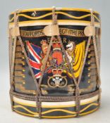 A 20th Century military related ice bucket in the form of a drum having a black cylindrical body
