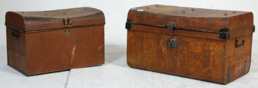Two vintage mid 20th Century metal travelling trunks both retaining original brown paint work with