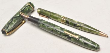 Two vintage green celluloid writing pens to include one fountain pen and one mechanical ballpoint