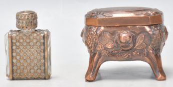A small copper trinket / pill souvenir box having embossed decoration with a landscape pane to the