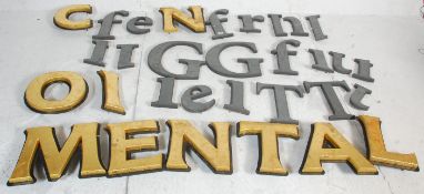 A collection of vintage wooden shop advertising wall mounting cut out letters most being a black