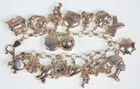 A silver hallmarked charm bracelet adorned with many silver charms to include a moon and sun