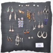 A collection of ladies earrings most being silver to include a pair of think hoop earrings, drop