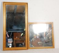 Two large vintage 20th Century wall mirrors to include a square mirror within a wooden frame and a