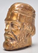 A brass vesta in the form of a historical man in a cap. Match striker to base. Measures 5cm. 38 40-
