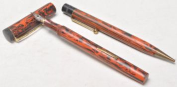 A pair of vintage early plastic writing pens to include a fountain pen and a mechanical ball point