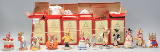 A group of twelve Royal Doulton Bunnykins ceramic rabbit figurines to include Christmas surprise