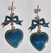 A pair of stamped silver ladies Georgian style drop earrings in the form of hearts with bows to