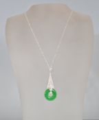 A stamped 925 silver pendant necklace having a triangular pendant set with white stones and a