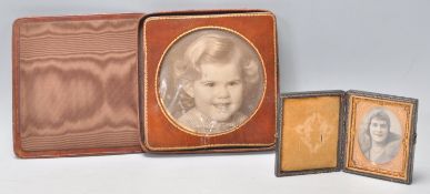 Two vintage early 20th Century leather bound photo frames to include a square cased example with