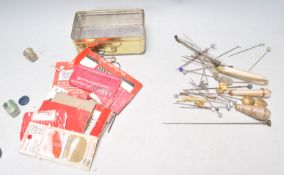 A collection of vintage hat pins dating from the early 20th Century to include a gilt eagle hat pin,