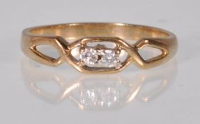 jA yellow gold crossover design ring set with two round cut diamonds. Gold unmarked. Weight 1.8g.
