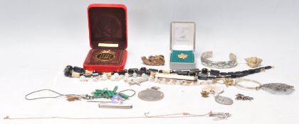 A collection of vintage costume jewellery to include a stamped sterling silver bangle set with