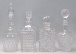 A group of four 20th Century cut crystal decanters two of square form and two of bottle form