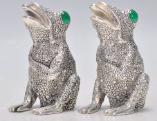 A pair of 925 silver condiments in the form of frogs having textures backs set with green stone