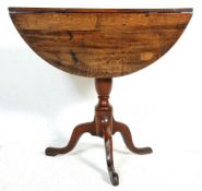 A 19th Century Victorian drop leaf occasional table having a round top raised on a turned knopped
