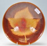 A vintage retro Poole pottery Aegean series plate of round form having  brown glaze with a large