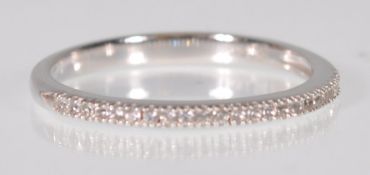 A stamped 14ct white gold half eternity ring set with round cut diamonds. Weight 1.6g. Size N.5.