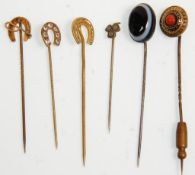 A group of six vintage ladies stick pins to include a 9ct gold horseshoe and crop example and two