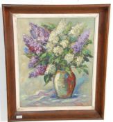 A 20th Century original oil on canvas still life painting depicting a vase of flowers set within a