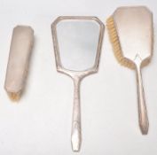 A silver hallmarked 1940's silver dressing table set to include a mirror, hair brush and clothes