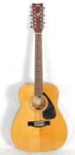 A good Yamaha FG-411-12 twelve string acoustic guitar having a white marked fretboard and chrome