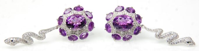 A pair of silver ladies dress earrings having a cluster of amethysts with drops in the form of