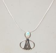 A stamped sterling silver pendant necklace having a snake chain with a Art Nouveau style pendant set