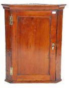 A 19th Century Georgian  / George III country pine hanging corner cabinet having a panelled door