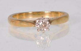 A hallmarked 18ct gold and diamond solitaire ring  illusion set with a round cut diamond. Hallmarked