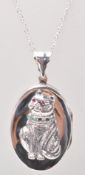 A stamped 925 silver pendant necklace having an oval locket with a raised cat wearing a collar set