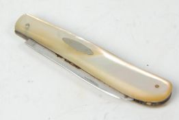An early 20th Century mother of pearl handled fruit knife having a silver hallmarked blade.