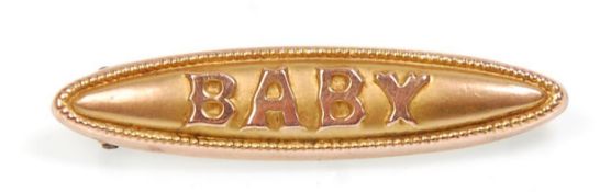 An early 20th Century 9ct yellow gold baby brooch. Total weight 1.0g. Measures 1.5 inches wide.