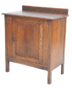 A early 20th Century oak cupboard having a gallery back with carved geometric panels above a