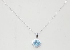 An 18ct white gold pendant necklace, the pendant set with a round cut topaz with a halo of diamonds.