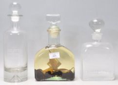 A vintage retro Danish glass decanter together with 2 other clear glass decanters, one marked for