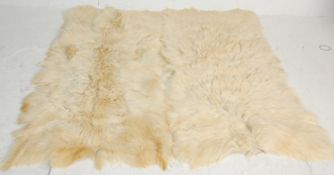 Two large 20th century retro sheepskin floor rugs of natural form. H169 W80cm