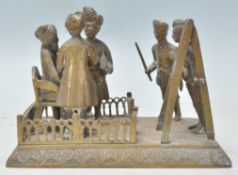 A mid 19th century Indian cast brass figurine group depicting a court marshall scene with a seated
