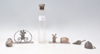 A group of silver items to include a silver topped scent bottle with a faceted glass bottle (
