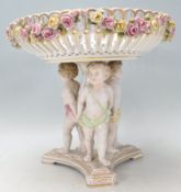 A 19th Century German tazza in the manner of Meissen having a round bowl hand painted with roses and