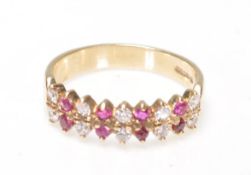 A 9ct gold ruby and diamond 18 stone ring. The ring with prong mounted rows of rubies and