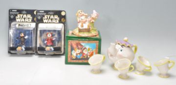 A collection of Disney figurines to include Snow White; Grumpy's Bathtime, a beauty and the Beast