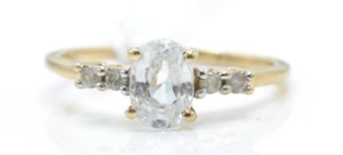 A hallmarked 9ct gold and white stone ring. The ring with a central oval mixed cut white stone
