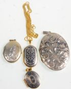 A group of four silver lockets to include two gilt examples having silver and black painted