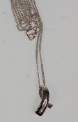 A 9ct white gold pendant necklace having a fine link chain with white gold pendant set with four
