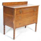 An early 20th Century 1930's oak chest of drawers, having a gallery back with three drawers with