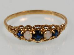An English hallmarked 9ct yellow gold ladies ring set with sapphires and opal cabochons on a