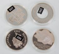 A group of four silver proof five pound coins to include Alderney 2004, Guernsey 1999, commemorative